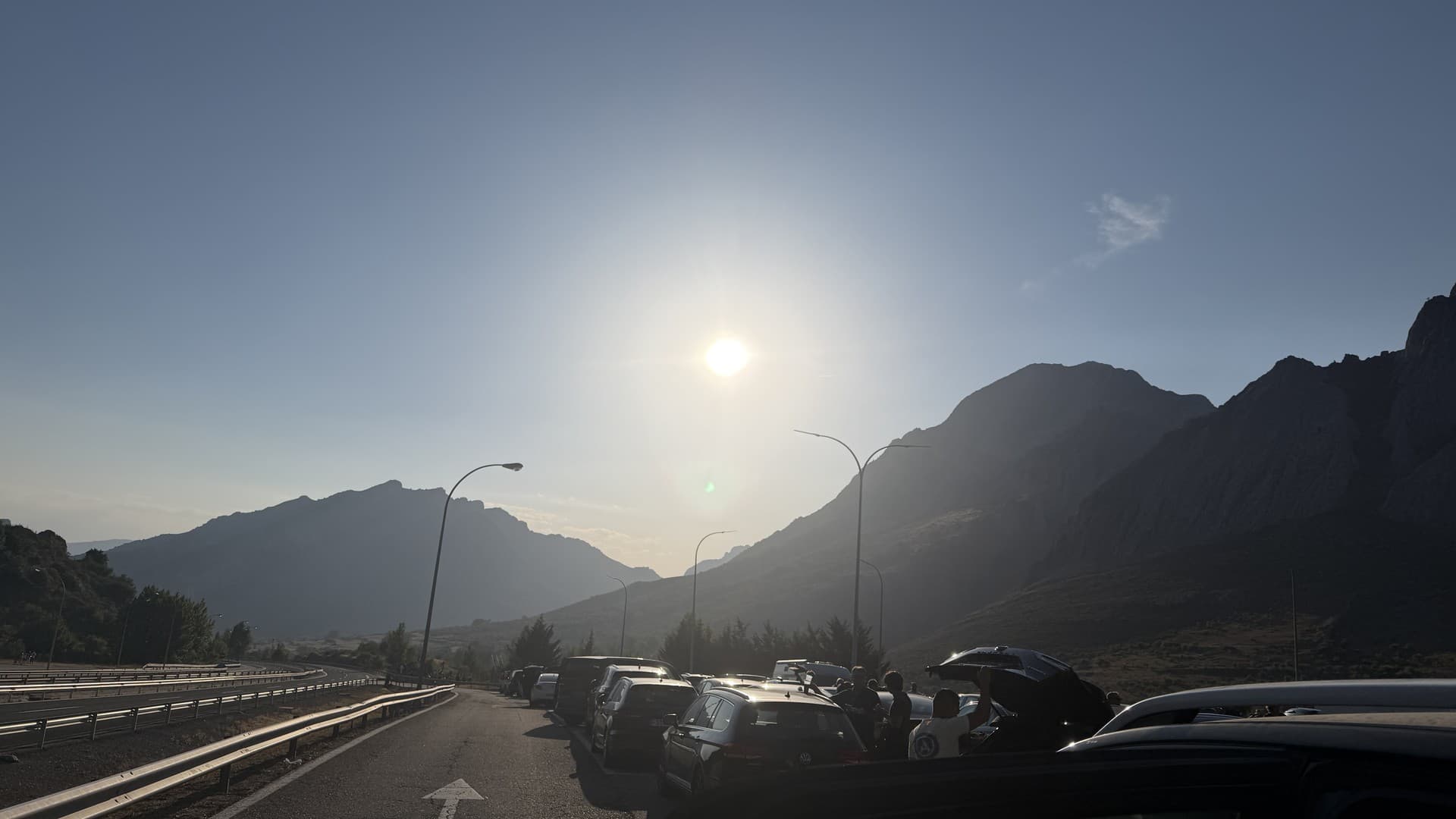 Cars line a mountain road in northern Spain as eclipse chasers wait for totality